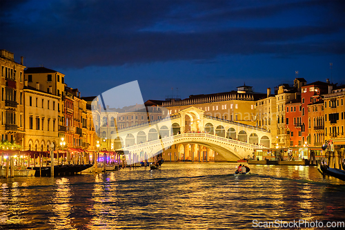 Image of Rialto bridge Ponte di Rialto over Grand Canal at night in Venice, Italy