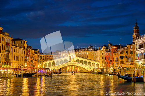 Image of Rialto bridge Ponte di Rialto over Grand Canal at night in Venice, Italy