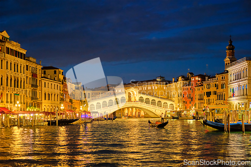 Image of Rialto bridge Ponte di Rialto over Grand Canal at night in Venice, Italy