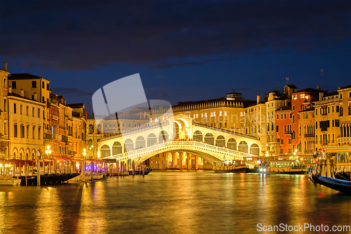 Image of Rialto bridge Ponte di Rialto over Grand Canal at night in Venice, Italy