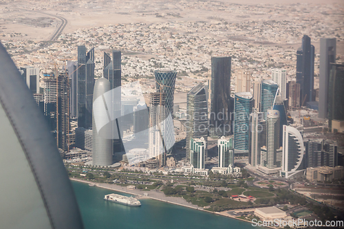 Image of Aerial view of Doha through plane window, capital of Qatar in the Persian Gulf