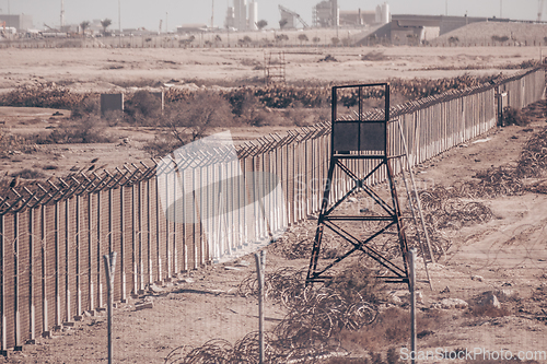 Image of Fanced bordeline, barbed wires and watchtower. Non-passable military zone
