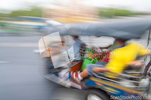 Image of Traditional tuk-tuk from Bangkok, Thailand, in motion blur.