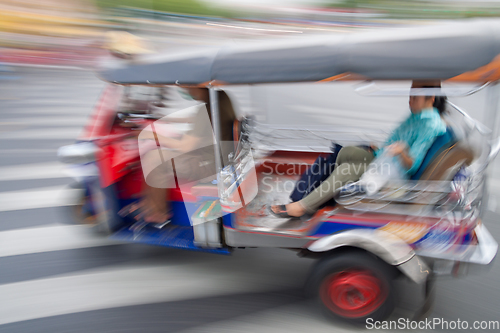 Image of Traditional tuk-tuk from Bangkok, Thailand, in motion blur.