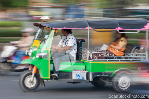 Image of Traditional tuk-tuk from Bangkok, Thailand, in motion blur.