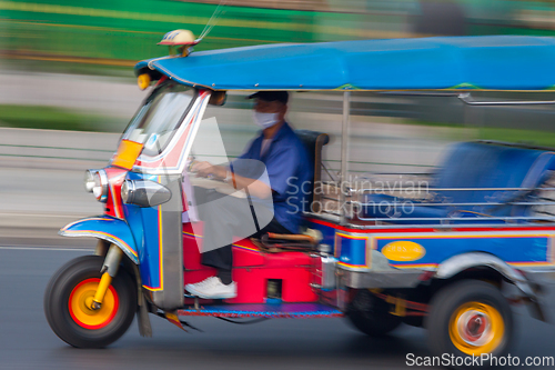 Image of Traditional tuk-tuk from Bangkok, Thailand, in motion blur.