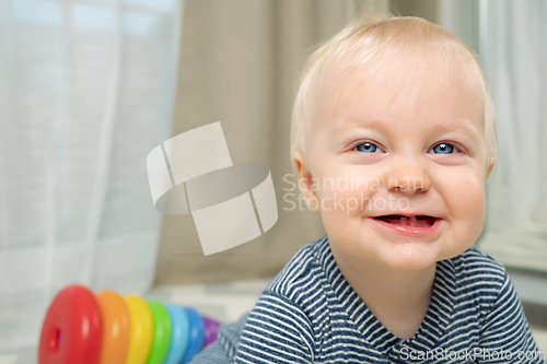 Image of Cute baby boy with toy - portrait