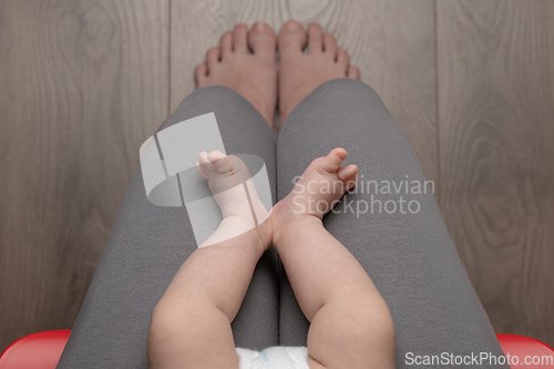 Image of Woman sitting on chair with baby - top view