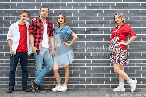 Image of Happy family near brick wall