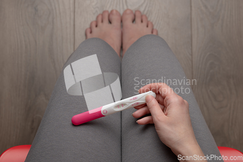 Image of Pregnant woman sitting on chair - top view