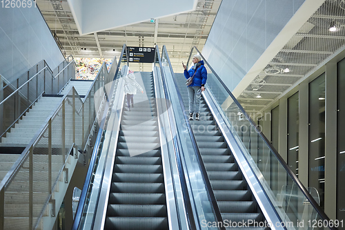 Image of Mother and child together on escalator background. Terminal, air