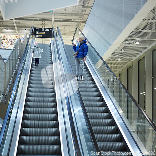 Image of Mother and child together on escalator background. Terminal, air