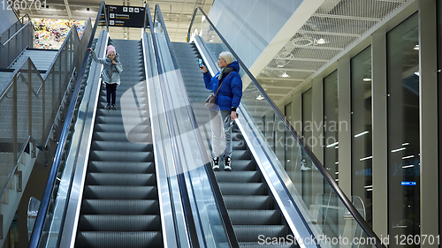 Image of Mother and child together on escalator background. Terminal, air