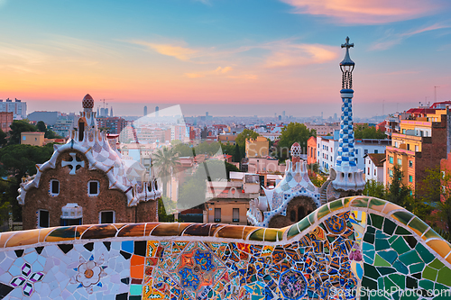 Image of Barcelona city view from Guell Park. Sunrise view of colorful mosaic building in Park Guell