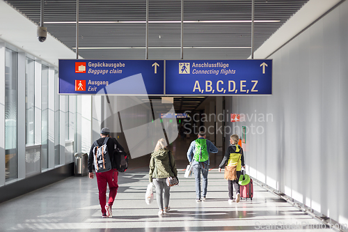 Image of Unrecognizable People With Bags And Suitcase Walking In Airport Terminal. Rear View Of Passengers On Their Way To Flight Boarding Gate, Ready For Business Travel Or Vacation Journey.