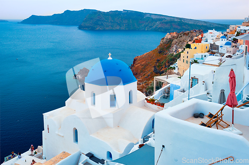 Image of Famous view from viewpoint of Santorini Oia village with blue dome of greek orthodox Christian church