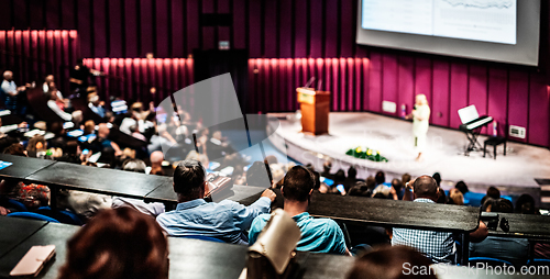 Image of Woman giving presentation on business conference event.