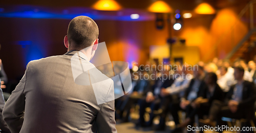 Image of Public speaker giving talk at Business Event.