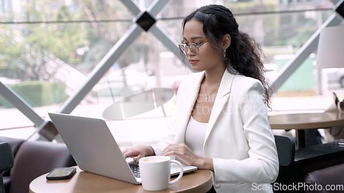 Image of Businesswoman Using Wireless Tech and Laptop While Enjoying Coffee