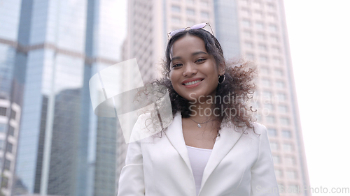 Image of Smiling Businesswoman Outside Corporate Skyscraper in the City.