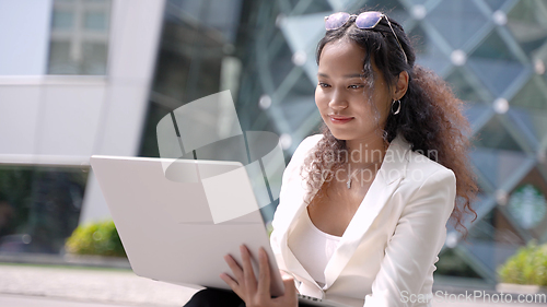 Image of Portrait of young asian businesswoman working on laptop