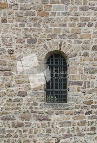 Image of wall with barred window