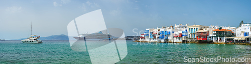 Image of Little Venice houses in Chora Mykonos town with yacht and cruise ship. Mykonos island, Greecer