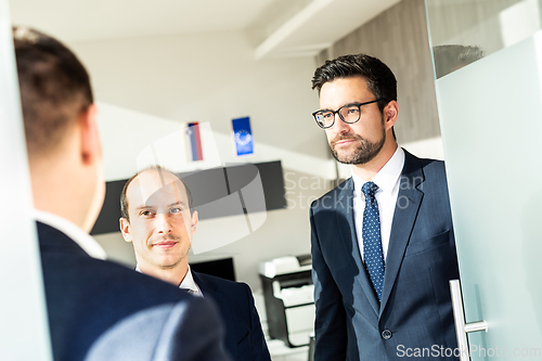 Image of Group of confident business people greeting with a handshake at business meeting in modern office or closing the deal agreement by shaking hands.