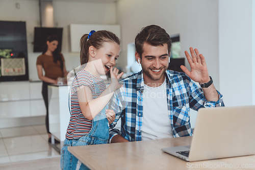 Image of Father and daughter in modern house talking together on laptop with their family during holidays. The life of a modern family