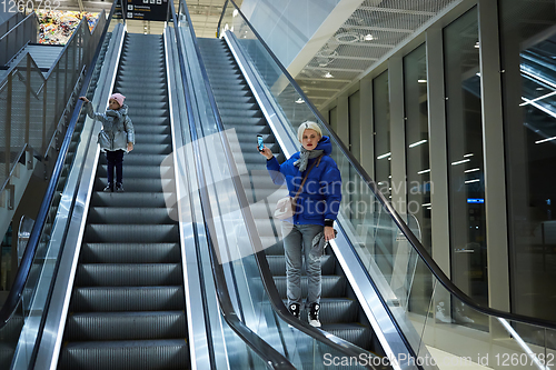 Image of Mother and child together on escalator background. Terminal, airport travel, love care.