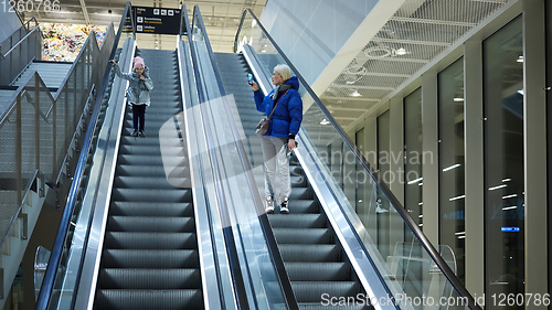 Image of Mother and child together on escalator background. Terminal, airport travel, love care.