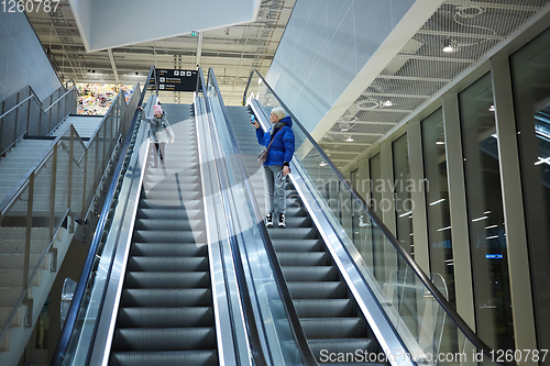 Image of Mother and child together on escalator background. Terminal, airport travel, love care.