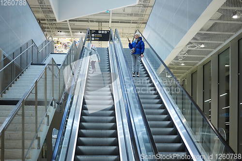 Image of Mother and child together on escalator background. Terminal, airport travel, love care.