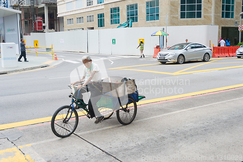 Image of Old man riding tricycle Singapore