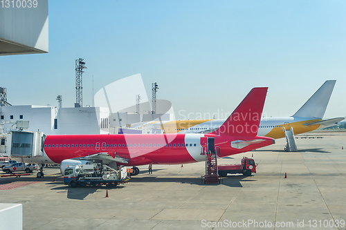 Image of Loading airplanes at airport runway 