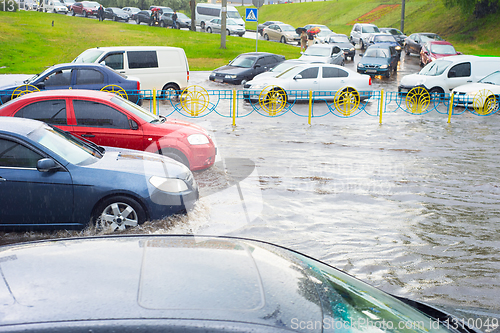 Image of car traffic on flooded street