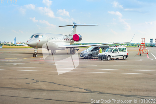 Image of Airplane and cars at runway