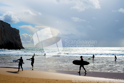 Image of Surfers silhouette surfboards beach Portugal