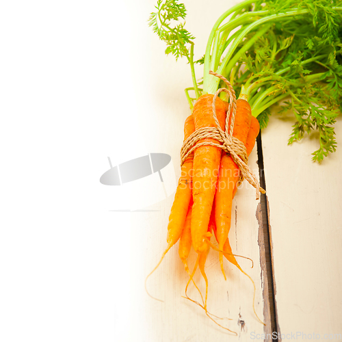 Image of baby carrots bunch tied with rope