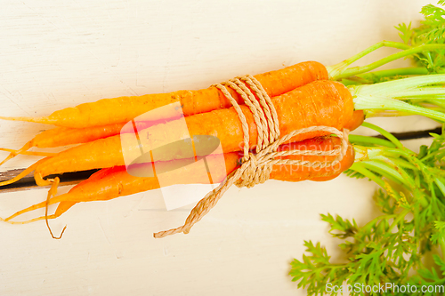 Image of baby carrots bunch tied with rope