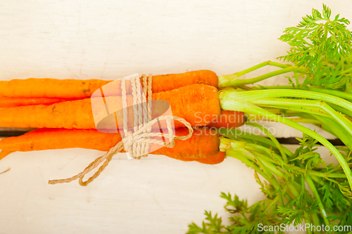 Image of baby carrots bunch tied with rope