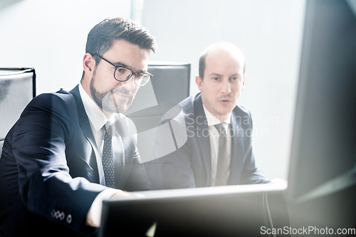 Image of Business team analyzing data at business meeting in modern corporate office.