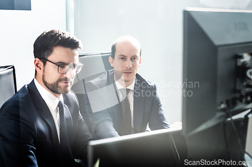 Image of Business team analyzing data at business meeting in modern corporate office.