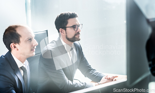 Image of Business team analyzing data at business meeting in modern corporate office.