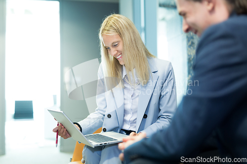 Image of Business meeting. Client consulting. Confident business woman, real estate agent, financial advisor explaining details of project or financial product to client in office.