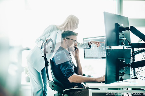 Image of Business team analyzing data at business meeting in modern corporate office.