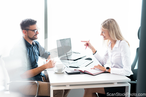 Image of Business meeting. Client consulting. Confident business woman, real estate agent, financial advisor explaining details of project or financial product to client in office.