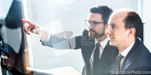 Image of Business team analyzing data at business meeting in modern corporate office.