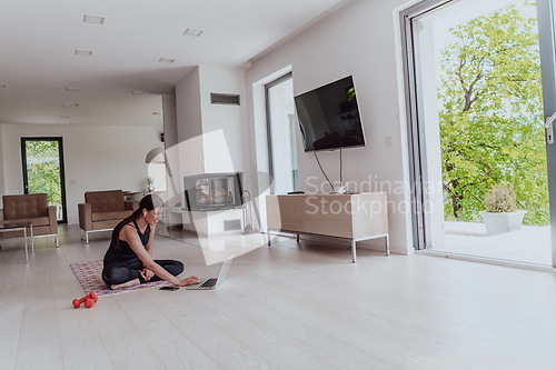 Image of Young Beautiful Female Woman with Trainer via Video Call Conference in Bright Sunny House. Healthy Lifestyle, Wellbeing and Mindfulness Concept.