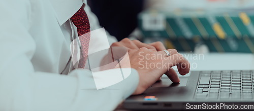 Image of Close up of business hands are typing on laptop.